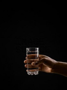 Person holding a glass of water