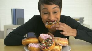 woman-eating-a-pile-of-donuts